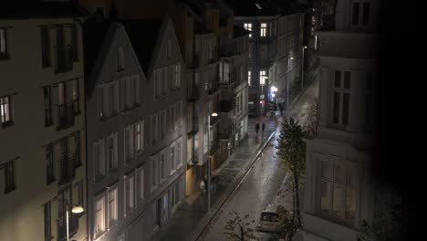 Nygaardsgaten-street-in-Bergen-Norway-Night-time-lapse---Static-clip-looking-down-at-busy-cars-and-people-during-saturday-night---Long-exposure-with-motion-blur-on-moving-subjects
