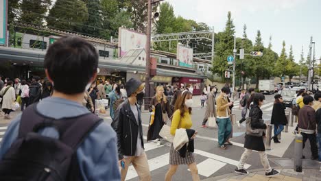 Harajuku-Train-Station,-Japanese-People-Crossing-Road-to-Fashionable-Area