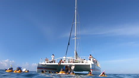 Tourists-snorkeling-and-moving-inside-catamaran-sailboat-in-middle-of-the-Caribbean-sea-|-catamaran-Snorkeling-tour-of-tourists-in-ocean-|-Lifestyle,-holidays,-tourism,-tourists,-travel