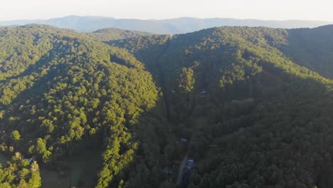 4K-Drone-Video-Flying-High-Above-Trees-Along-Mountain-Road-in-Smoky-Mountains-near-Asheville,-NC-on-Foggy-Morning
