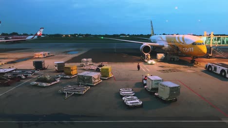 Time-lapse-ground-staff-Preparing-the-aircraft-before-flight-Loading-of-baggage-Food-for-flight-services-and-equipment-before-boarding-the-airplane-at-night-time-at-kl-city