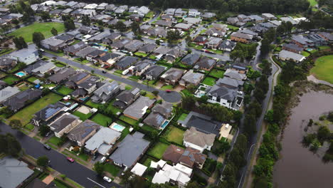 Aerial-shot-of-Australian-residential-suburb-large-houses-by-lake---Colebee-NSW