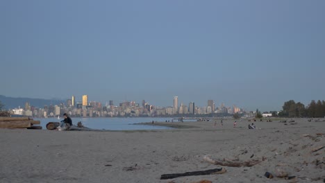 People-On-Sandy-Spanish-Banks-Beach-With-View-Of-English-Bay-And-Downtown-Vancouver-In-British-Columbia,-Canada