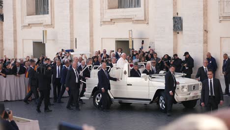 People-greeting-the-pope-Francisco-in-his-popemobile-car-in-Vatican-city-cinematic-slow-motion