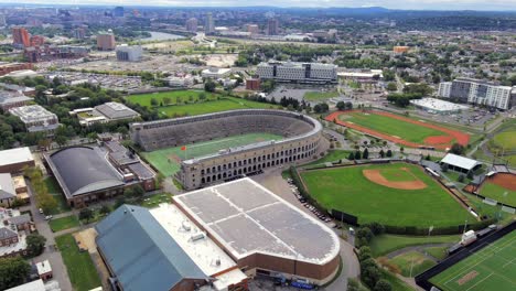Harvard-University-sports-complex-and-the-Boston-City-Skyline---tilt-down-aerial-view