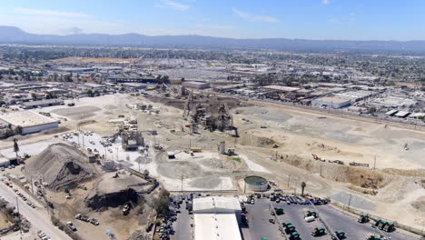 Large-open-pit-quarry-provides-construction-aggregate:-gravel,-sand,-stone,-rock,-asphalt---aerial-view