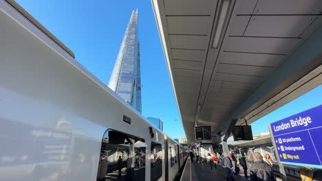Train-leaving-London-Bridge-train-station-with-The-Shard-skyscraper