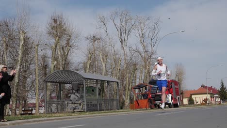 Panning-Shot-Of-Woman-Running-During-A-Marathon,-Croatia,-Durdenovac,-2022,-Slow-motion