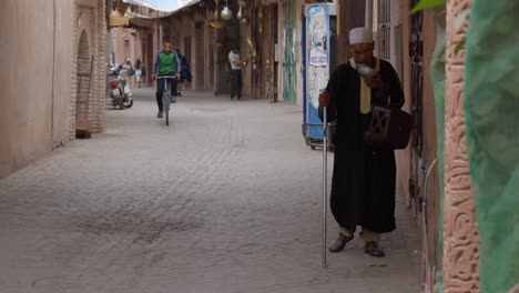 Homeless-blind-man-walking-with-white-stick-in-old-Marrakesh-street