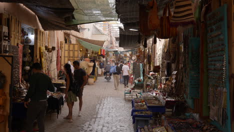 Menschen-Und-Motorräder,-Die-Durch-Den-Marokkanischen-Straßenmarkt-Reisen