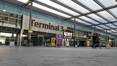 6th-November-2022---Terminal-3-Departures-Entrance-At-Heathrow-Airport-With-People-And-Virgin-Cabin-Crew-Member-Walking-Past