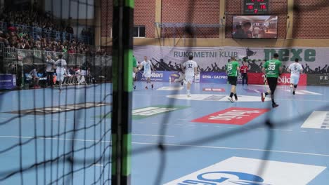 Handball-Match,-Man,-SEHA,-Europe,-Player-score-a-goal,-look-behind-net