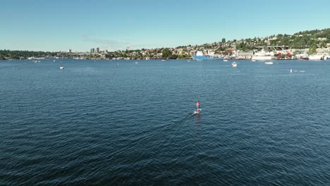 Drone-shot-following-an-electric-surfboard-through-Lake-Union-in-Seattle