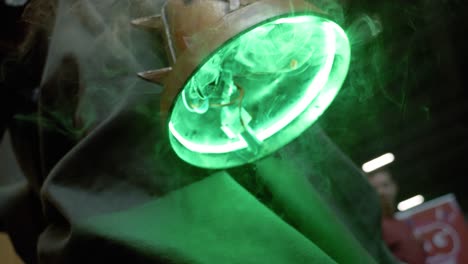 Slowmotion-close-up-shot-of-a-bright-green-neon-lamp-with-smoke-trailing