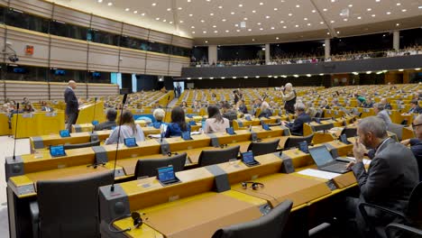 People-inside-hemicycle-of-European-Parliament-headquarter-in-Brussels,-Belgium