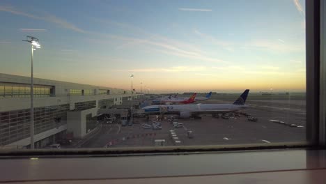 Airplanes-at-Brussels-airport-arriving-and-parking-at-sunrise-in-disembarkation-area