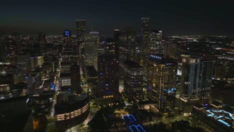 Aerial-view-around-illuminated-downtown-Houston-from-the-east-side-of-the-city
