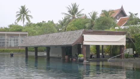 View-of-thai-style-architecture-building-with-huge-swimming-pool-inside-JW-Marriott-Khaolak-Resort-and-Spa-in-summer-holiday-time
