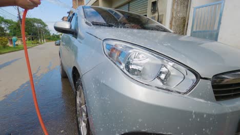 Angra-dos-Reis,-Rio-de-Janeiro,-Brazil---October-17,-2022-Washing-car,-removing-soap-from-car