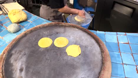 shot-of-a-person-preparing-tortillas-on-a-griddle-in-Oaxaca