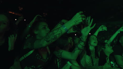 Young-Tattooed-Woman-Lady-Holding-Cell-Phone-Filming-and-Singing-During-Music-Concert-Show,-Audience-Crowd-Ladies-in-Arena-Filming-Music-Performance-on-Stage