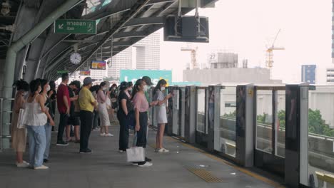 View-on-platform-of-BTS-skytrain-station-with-many-passenger-waiting-for-train