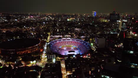 Music-event-at-the-Ciudad-de-los-deportes-venue,-nighttime-in-Mexico-city---aerial-view