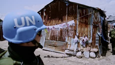 Peacekeeping-patrol-walk-on-the-narrow-streets-of-Cité-Soleil,-UN-mission