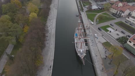 The-Dane-river-flowing-in-the-center-of-the-city,-where-the-old-town-is-on-the-right-bank,-the-park-has-been-renovated-on-the-left-bank,-and-the-Meridian-sailing-ship-stands-in-the-river