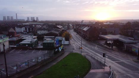 Rainy-early-morning-sunrise-aerial-view-above-British-car-dealership-in-industrial-town-estate