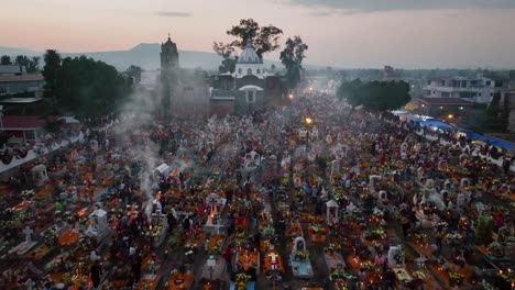 Aerial-view-over-people-respecting-the-dead-at-a-graveyard,-during-Dia-de-Muertos,-in-Mexico-city
