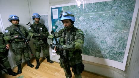 Tactical-command-center-of-UN-forces,-soldiers-getting-ready-for-a-mission