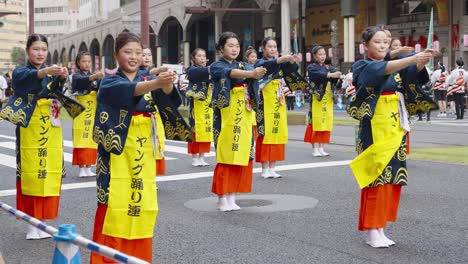 Young-Japanese-women-dancing-in-unison-at-traditional-Ohara-Festival,-Kagoshima