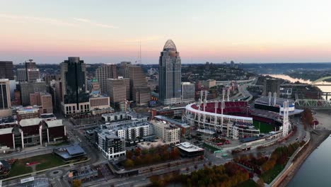 Aerial-view-towards-the-Great-American-tower,-fall-sunrise-in-Cincinnati,-USA---tilt,-drone-shot