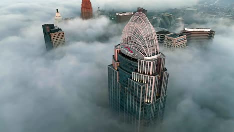 Aerial-view-around-the-Great-American-tower,-foggy-morning-in-Cincinnati,-USA---circling,-drone-shot