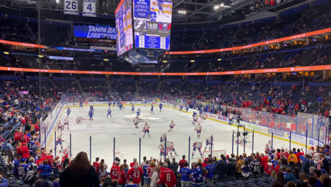 Hockey-Teams-Warming-Up-On-The-Ice-Rink-With-Audience-Watching