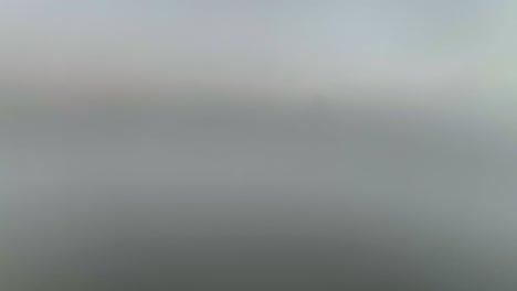 Aerial-view-through-fog-revealing-the-skyline-of-Cincinnati,-sunrise-in-Ohio,-USA---rising,-drone-shot