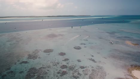 Drone-shot-forward-movement-People-kitesurf-caribbean-sea,-kite-safari-Los-Roques
