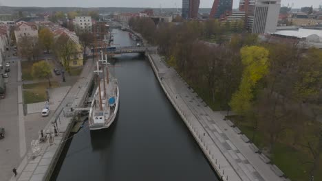 The-Dane-river-flowing-in-the-center-of-the-city,-where-the-old-town-is-on-the-left-bank,-the-park-has-been-renovated-on-the-right-bank,-and-the-Meridian-sailing-ship-stands-in-the-river