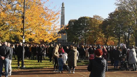 Crowd-gathering-at-UK-park-memorial-Cenotaph-paying-respect-on-remembrance-Sunday-service