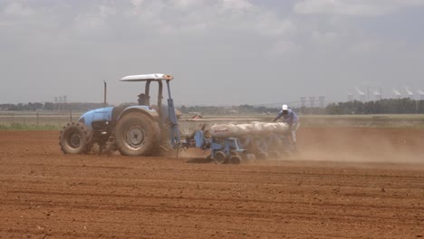 Two-South-African-farmers-plant-food-crop-in-freshly-tilled-field