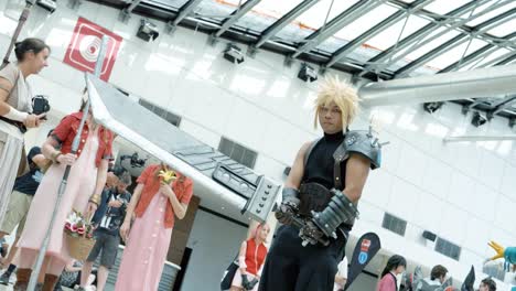 Man-in-cosplay-costume-with-a-big-sword-slash-in-front-of-the-camera