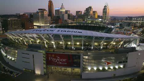 Aerial-view-in-front-of-the-entrance-to-the-Paycor-Stadium,-vibrant-sundown-in-Cincinnati,-USA---descending,-drone-shot