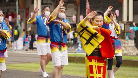 Elderly-Japanese-Woman-Leads-Group-of-Dancers-at-Ohara-Festival,-Kagoshima