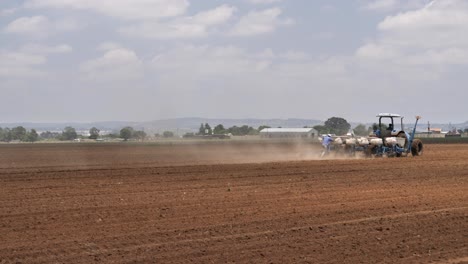 Dust-rises-as-farmers-plant-seeds-in-fertile-top-soil-in-Agri-field