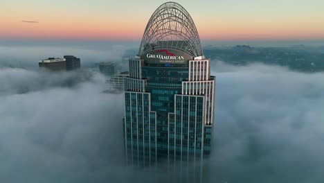 Aerial-view-around-the-Great-American-tower,-foggy-sunrise-in-Cincinnati,-USA---orbit,-drone-shot