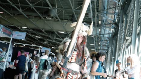 Woman-dressed-up-in-Neanderthal-costume-with-an-axe-sword-swinging-it-around-at-the-Japanese-Expo-2022