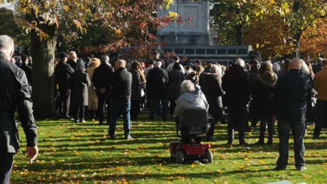 People-gathering-at-UK-park-memorial-Cenotaph-paying-respect-on-remembrance-Sunday-service