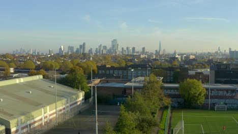 Descending-aerial-shot-of-London-skyline-into-north-london-suburbs