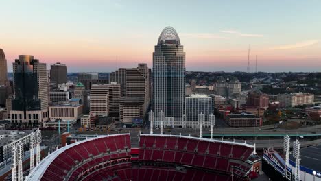 Aerial-view-over-the-Ball-Park-towards-the-Great-American-tower,-sunrise-in-Cincinnati,-USA---rising,-drone-shot